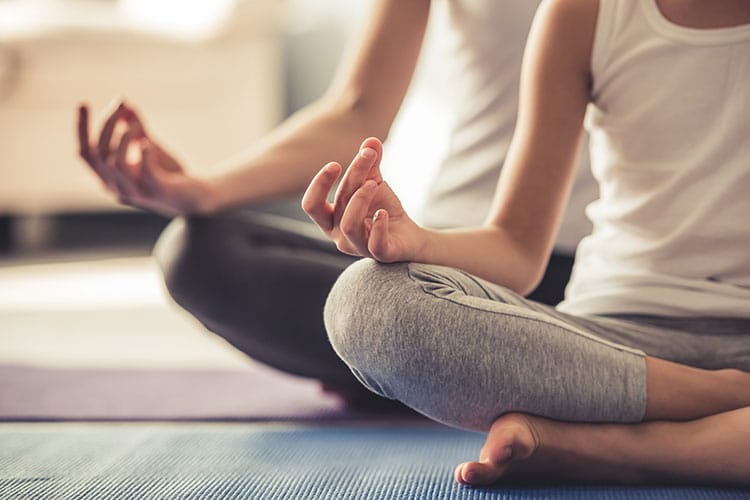 A man and women meditating.