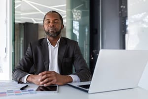 A business man meditating at work