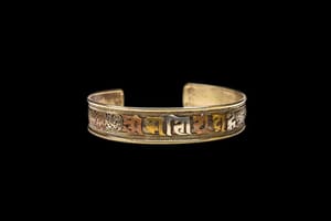 An old brass and copper Nepalese Om Mani Padme Hum cuff-bracelet